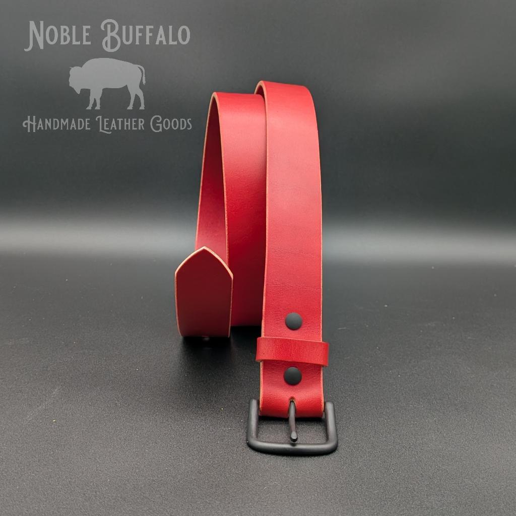 Poppy Red full grain leather belt handmade in the USA by Noble Buffalo. Bright red leather belt in poppy red and cherry red tones. Unisex colorful statement leather belt.