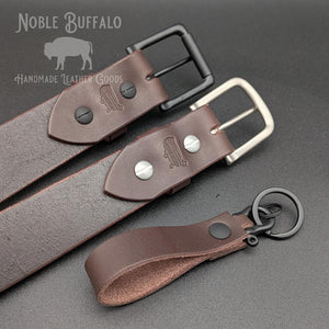 Handmade smoked walnut brown leather belt by Noble Buffalo. Deep dark brown full grain leather belt with smoky espresso and ash brown tones. Classic unisex leather belt accessory.